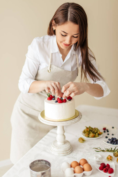 talented chef covering dessert with sweet fresh berries - Φωτογραφία, εικόνα