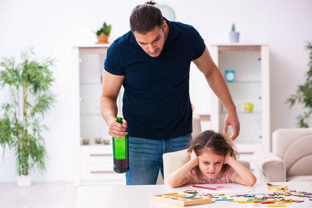 Drunk father and little girl indoors - Foto, Bild