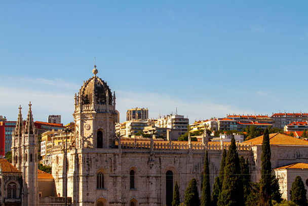 Stadtbild von Lissabon, Portugal vom Ufer des Tejo aus gesehen. Bild zeigt Dächer und Außenwände mehrerer Gebäude, darunter das Jeronimos-Kloster, das zum Weltkulturerbe gehört. - Foto, Bild