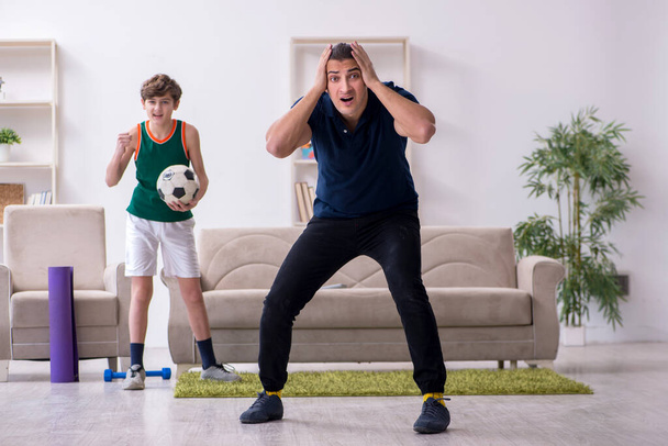 Father and son doing sport exercises indoors - Foto, Bild