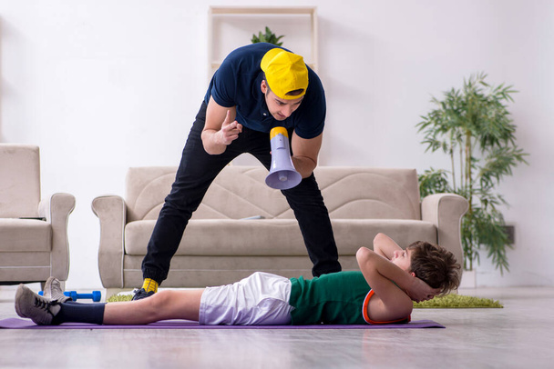 Father and son doing sport exercises indoors - Valokuva, kuva