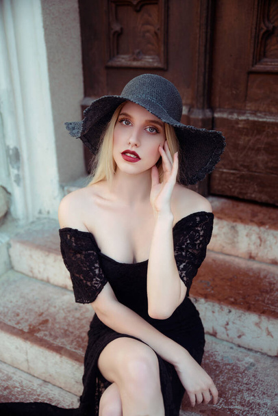 Gorgeous young woman in black hat posing  - 写真・画像