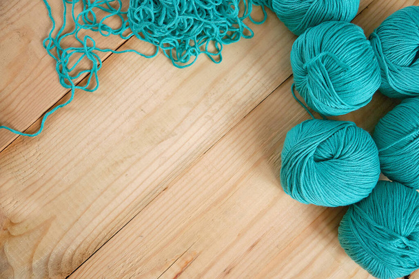 Balls of yarn on a wooden background, free space for text - Photo, Image