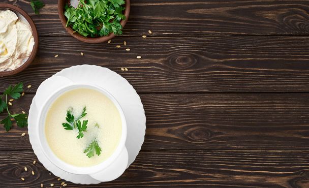 Domowej roboty zupa z jogurtu tureckiego (zupa yayla), sezonowa, letnia zupa, podawana na ciepło lub zimno. Zdrowe zdrowe jedzenie, pierwsze danie startowe. Widok z góry, przestrzeń kopiowania - Zdjęcie, obraz