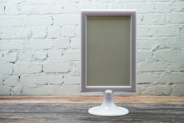 Blank Display frame stand on wooden background - Fotografie, Obrázek