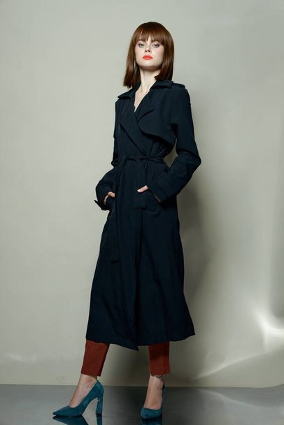 Funny fashion model coat photo studio brown hair - Valokuva, kuva