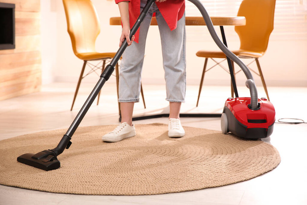 Young woman using vacuum cleaner at home, closeup - Φωτογραφία, εικόνα