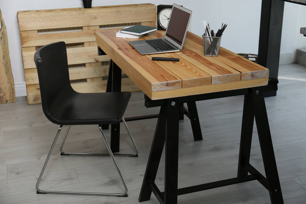 Comfortable workplace with office chair and wooden table - Foto, Bild