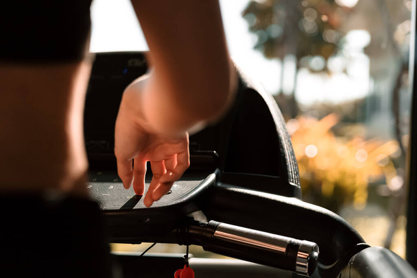 finger press botton running treadmill at gym for cardio. Fitness workout concept. - Valokuva, kuva