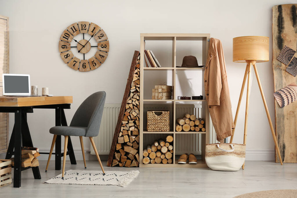 Stylish room interior with firewood as decorative element - Фото, изображение