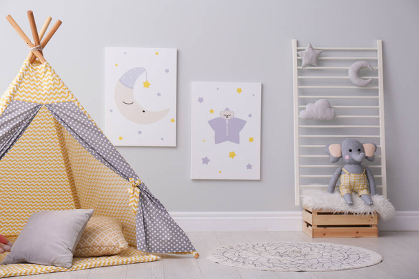 Stylish child's room interior with adorable paintings and play tent - Foto, Imagen