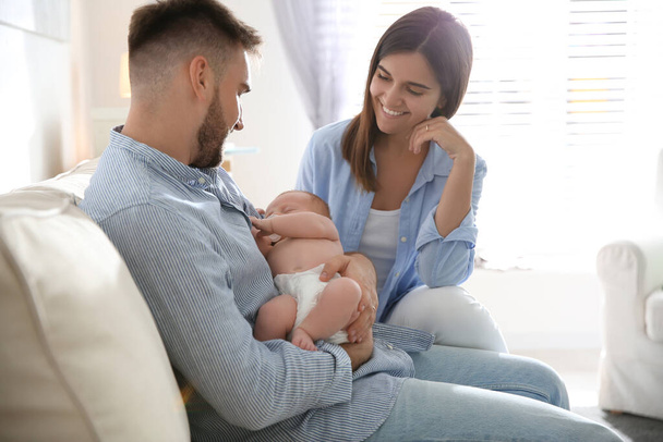 Happy couple with their newborn baby at home - Fotoğraf, Görsel