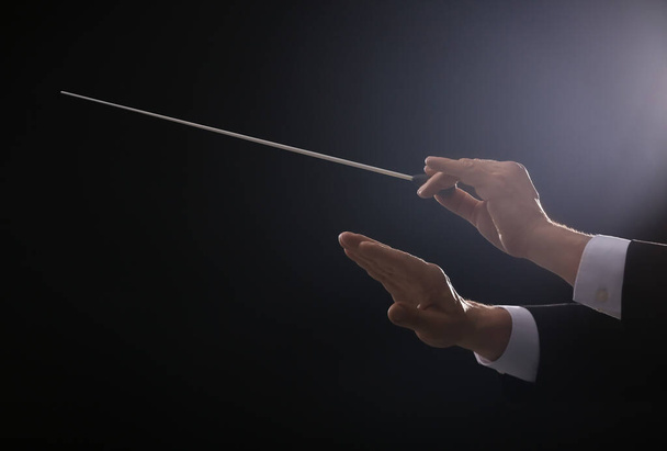 Hands of male conductor on dark background - Photo, Image