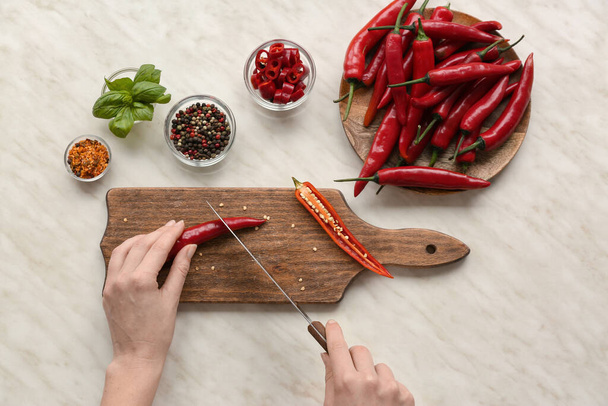 Woman cutting hot chili pepper, top view - Photo, Image