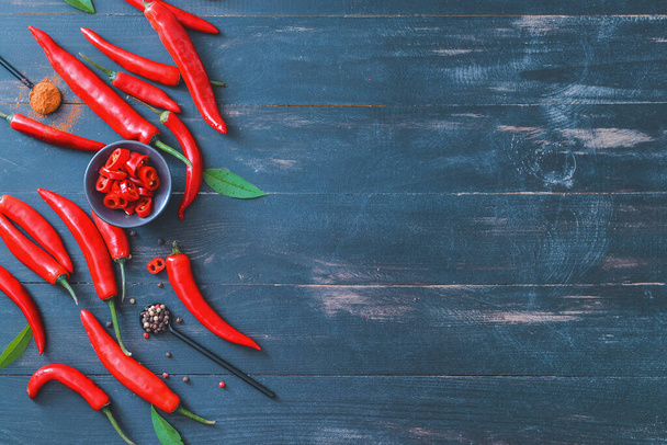 Hot chili pepper with spices on dark wooden background - Photo, Image