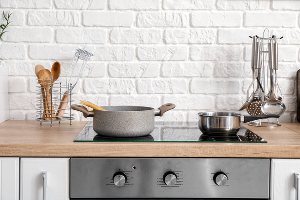 Utensils on stove in kitchen - Photo, Image