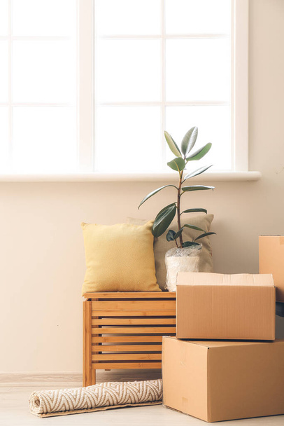 Cardboard boxes with belongings in new flat on moving day - Photo, image