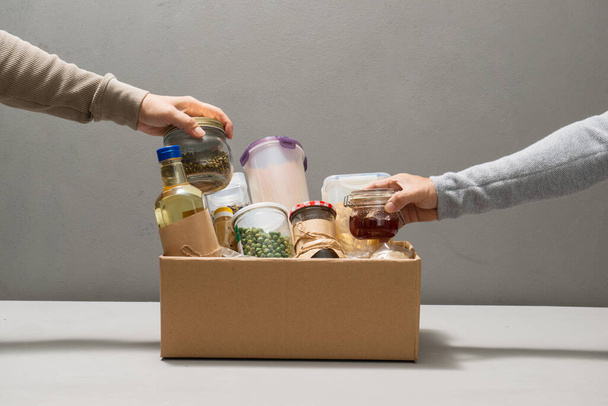 Volunteers taking food out of donation box on table - Valokuva, kuva