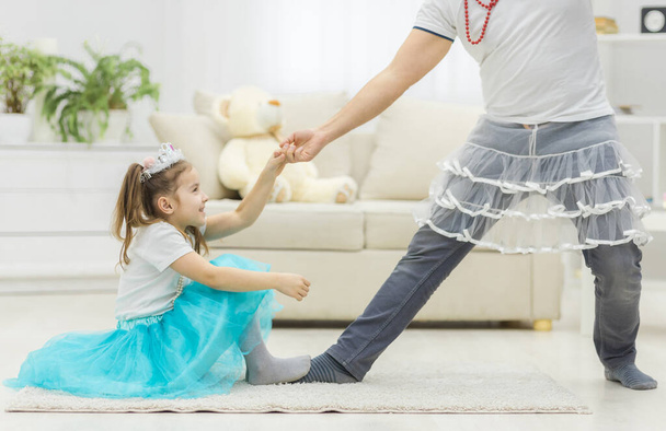 Photo of handsome young man dancing at home with his little cute girl. - Foto, Bild
