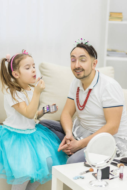 Photo of talanted daughted doing make-up to her dad. - Foto, immagini
