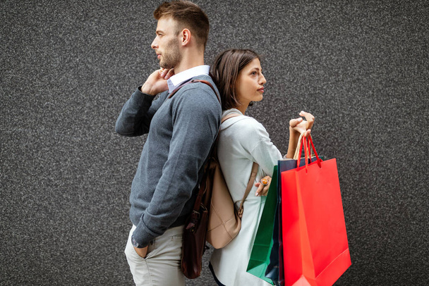 Sale travel love consumerism and people concept. Happy couple with shopping bags in the city - Фото, изображение