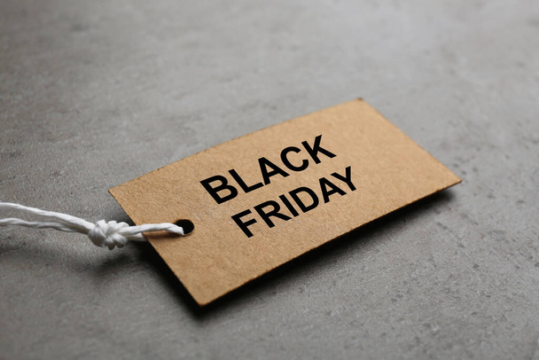 Blank tag on light grey stone background, closeup. Black Friday concept - Foto, afbeelding