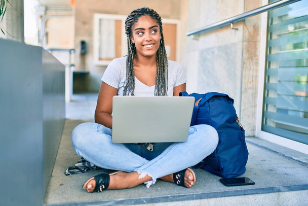 Young african american student woman smiling happy using computer laptop at the university campus - Φωτογραφία, εικόνα
