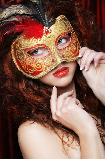 Young woman in a red mysterious mask - Фото, зображення