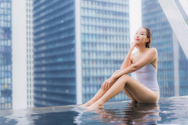 retrato hermosa joven asiática mujer relajarse sonrisa ocio alrededor al aire libre piscina en hotel resort - Foto, imagen