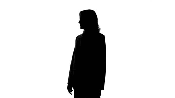 Womans silhouette with quiet gesture on isolated white background - Footage, Video