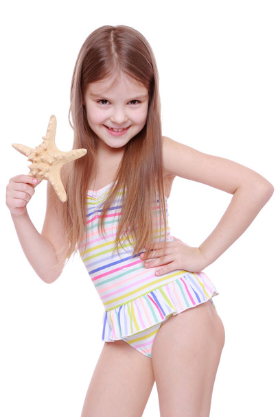 Girl in swimsuit with sea star - Фото, изображение