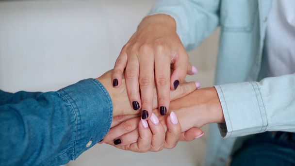 Close up of female young hands holding an elderly womans hands - Photo, image