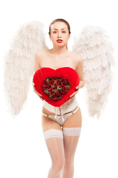 Young blond woman in angel costume holding heart - Photo, Image