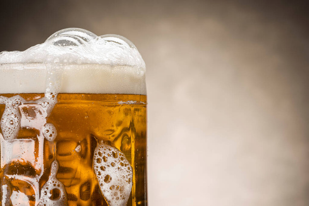 close up of beer pint with foam on rustic background - Photo, image