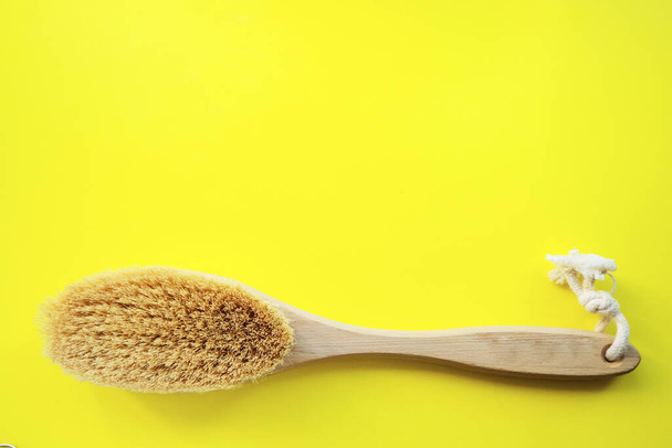 Body brush and anti-cellulite massage on a yellow background. Flat design with copy space. Cactus Exfoliating Body Care Brush - Foto, Imagen