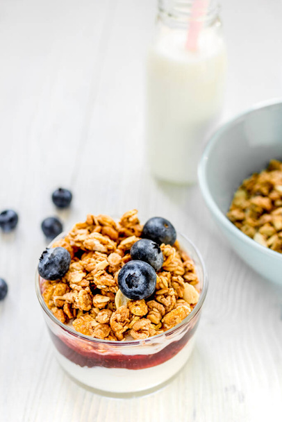 Healthy morning with granola breakfast on white kitchen table - Foto, afbeelding