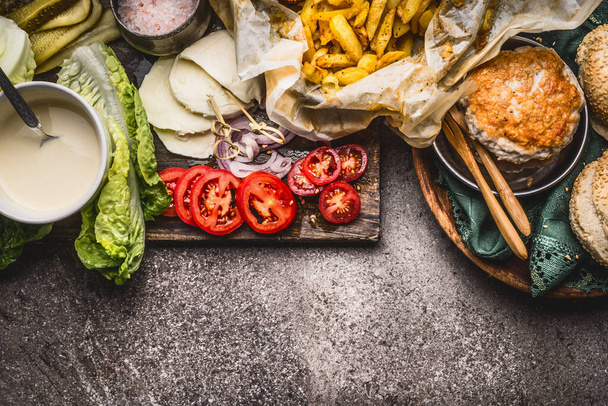 Tasty ingredients for chicken burger on rustic background , top view, border - Foto, afbeelding