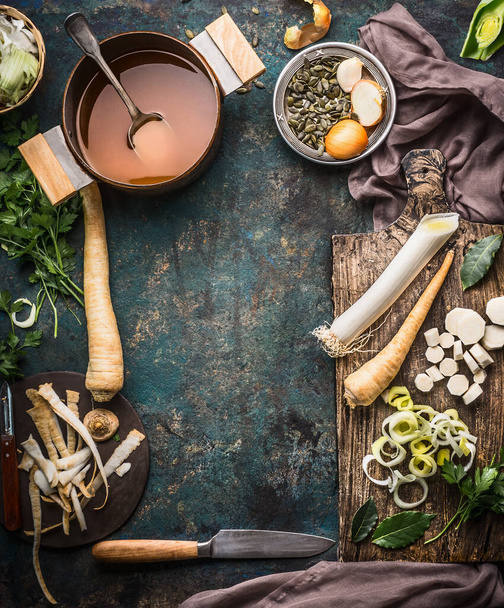 Food background with fresh parsnips roots on dark kitchen tables with knife. Top view. Vegetables cooking concept - Foto, afbeelding