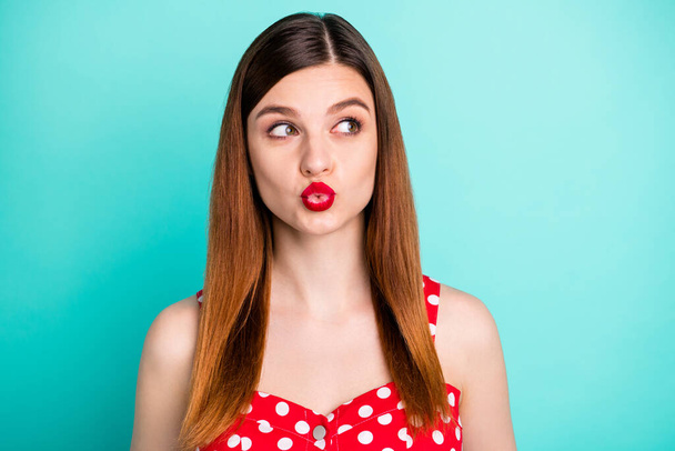 Closeup photo of pretty lady bright lipstick send kisses handsome guy boyfriend coquettish girlish look side empty space wear red dotted retro dress singlet isolated teal color background - Фото, зображення