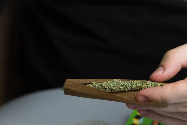 Cannabis rolled in blunt paper for smoking. Treatment of depression and anxiety. Marijuana legal use in healthcare - Photo, image