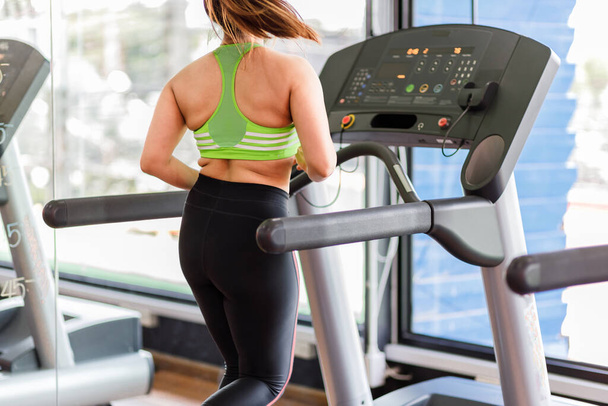 Women running in a gym on a treadmill.exercising concept.fitness and healthy lifestyle. Concept of healthy life. - Photo, Image