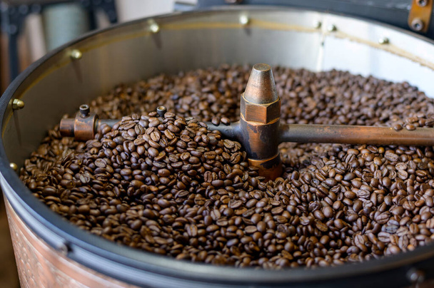 Coffee beans is roasting in roaster machine in coffee shop.  - Fotó, kép