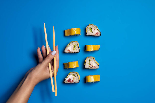 sushi and rolls on a bright colored background - Фото, зображення