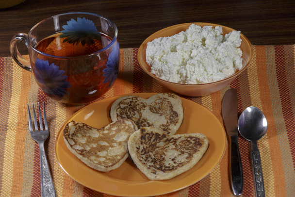 Breakfast at Valentine's Day. Pancakes, jam, cottage cheese and tea.  - Photo, Image
