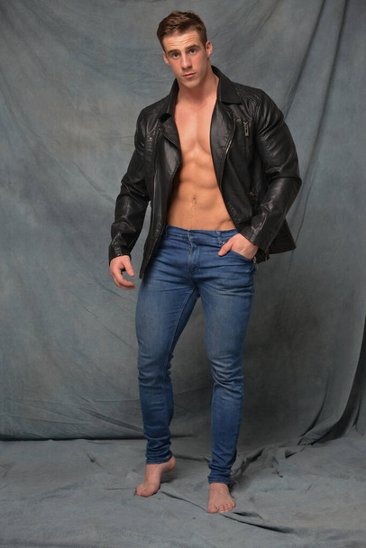 Fitness male model in leather jacket - Fotó, kép
