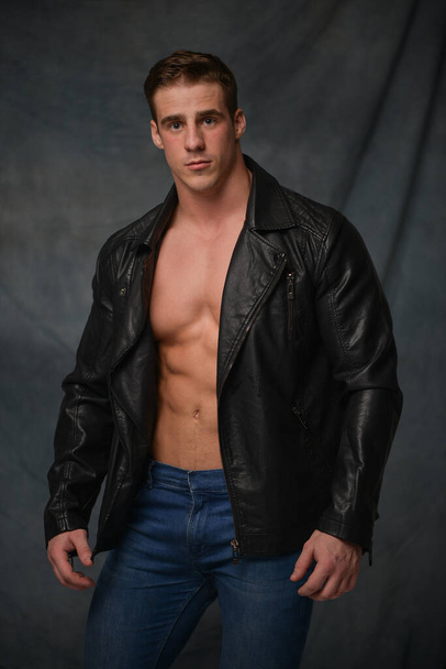 Fitness male model in leather jacket - Foto, Imagen