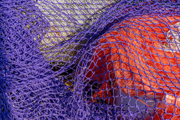 Close up of a colored fishing nets drying in the sun red, green and purple - Photo, Image