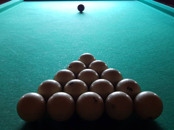 Russian billiards. Roll the ball into the pocket. Snooker competition. Equipment for bars and pubs. Money gambling. Hit the ball with a cue. Green cloth of a billiard table. - Photo, Image
