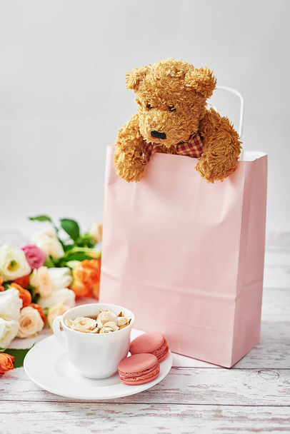 Flowers and gifts for women's day. Mother's day greeting card. Gift package. Bouquet of flowers in vase. Happy Birthday! Valentine's day gift. 14th February. Love concept. Stuffed toys Bear. - Photo, Image