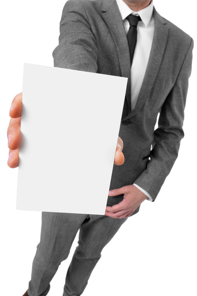 Человек в костюме держит пустую вывеску
 - Фото, изображение